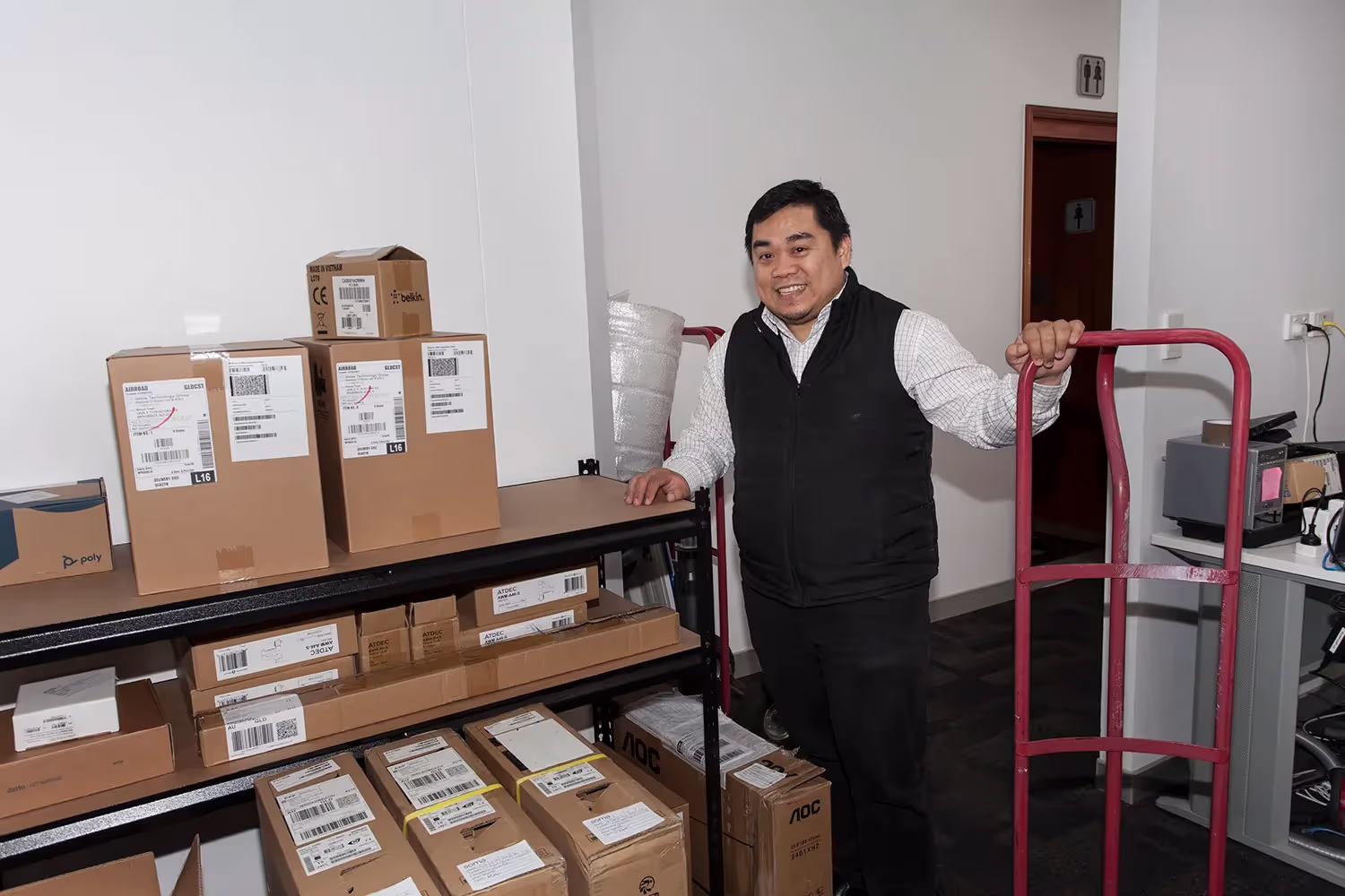 Technician donating gently used tech equipment to a Sydney-based education charity