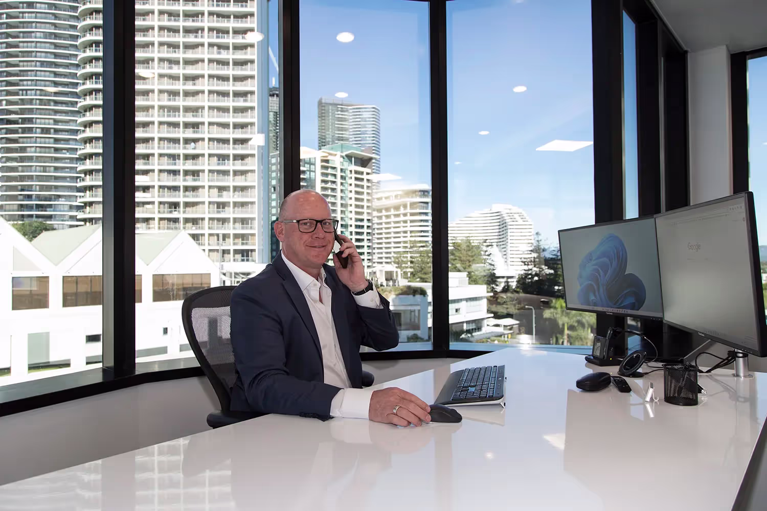Sydney business owner meeting with an IT consultant at a café near the Sydney CBD, discussing tech challenges
